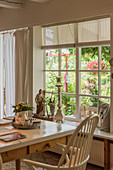 View from country-house-style dining room into summery garden
