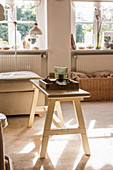 Rustic bench used as coffee table in sunny living room