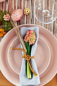 Hyacinth, ear of barley and napkin on pink plates
