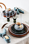 Pheasant feathers on table set in blue and natural shades