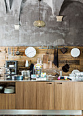 Kitchen counter with wooden base cabinets, wooden splashback and steel worksurface