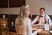 Bride and groom sitting at set table