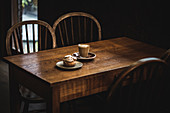 Coffee and pastry on wooden table in cafe