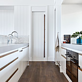 Modern kitchen with white fronts and pantry