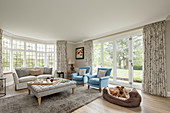Sofa set and dog in dog basket in bright living room
