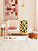 Cot in the children's room in nude tones with graphic patterns
