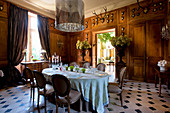 Wood-panelled walls decorated with hunting trophies in stylish dining room