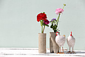 Ranunculus, floss flower and anemones in handmade concrete vases