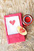 Heart printed on paper with pinked edge tucked into linen napkin