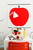 Picture of red apple above dining table in office