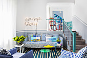 Blue-and-white polka-dot sofa set next to steps in split-level interior