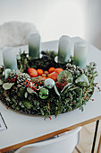 Modern Advent wreath with fruit in the centre and ombre candles