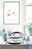 Picture of flowers above set table with spring decorations in pastel shades