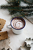 Cocoa in enamel mug, Spekulatius spiced biscuits and fir branch
