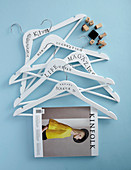 Coat hangers decorated with stamped lettering and used as magazine holders