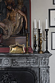 Candlesticks and religious relief on antique mantelpiece