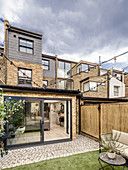 Garden, paved terrace and conservatory of terraced house