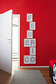 Red wall decorated with name made from framed letters