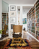 Easy chair on retro long-pile rug next to bookcase