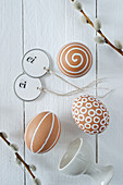 Blown brown eggs decorated with white patterns