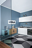 Glass wall screening retro-style kitchen with graphic pattern on floor