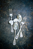 Vintage cutlery on dark surface