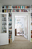 Fitted bookcase surrounding doorway leading into bedroom