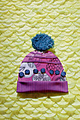 Composition of materials and fabrics in shape of a bobble hat