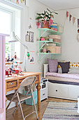 Old wooden table used as desk in vintage-style child's bedroom