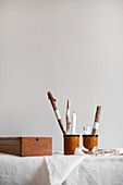Bohemian-style arrangement of sticks and candles in beakers