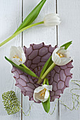 White tulips in decorative glass bowl