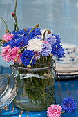 A bouquet of mixed-color cornflowers