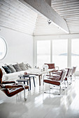 Leather armchairs in white, light-flooded living room