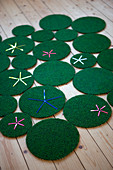 Rug made from green circles of different sizes with star motifs