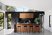 Bar stool at the kitchen island in the modern architect's house