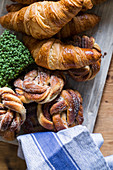 Croissants and sugared knots on wooden board