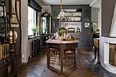 Rustic wooden table in country-house-style dining room with wooden floor