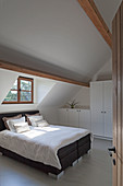 Box-spring bed in bedroom in modern country-house style