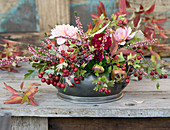 Autumn arrangement with dahlias, hawthorn berries, ling and medlar fruits