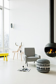 White floor and suspended fireplace in modern living room of loft apartment