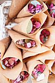 Hydrangea-petal confetti in paper cones