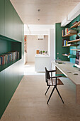 Study with green walls and built-in shelves