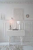 Drop-leaf table against panelled wainscoting in white living room