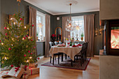 Festively set table in classic dining room decorated for Christmas