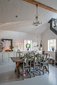 Festively set table in classic dining room with high ceiling