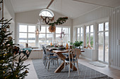 Set table in Scandinavian-style conservatory decorated for Christmas