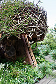 Tree house made of branches in bird's nest look, rustic ladder