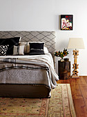 Double bed with headboard upholstered in diamond-patterned fabric