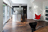 Classic, red Butterfly Chair in open-plan kitchen with island counter
