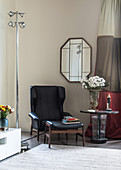 Black leather armchair and side table in corner
